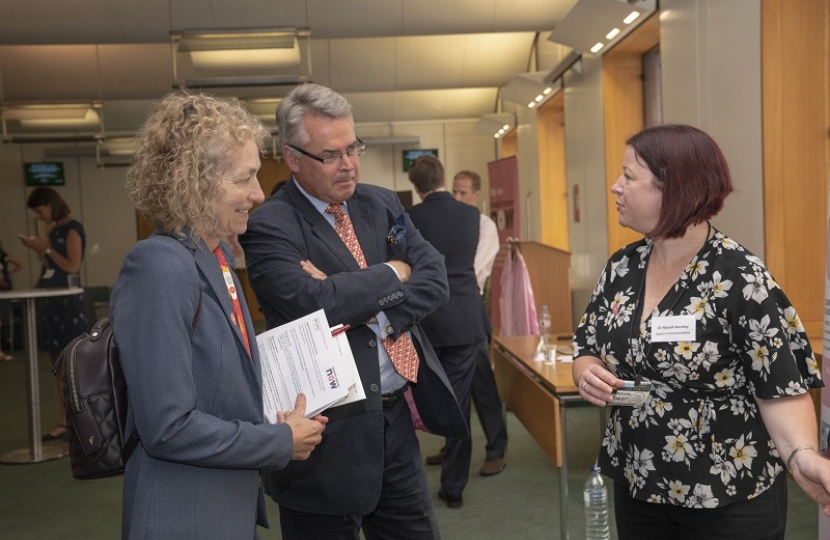 Tim Loughton MP gets behind the microscope at Breast Cancer Now research fair in Parliament